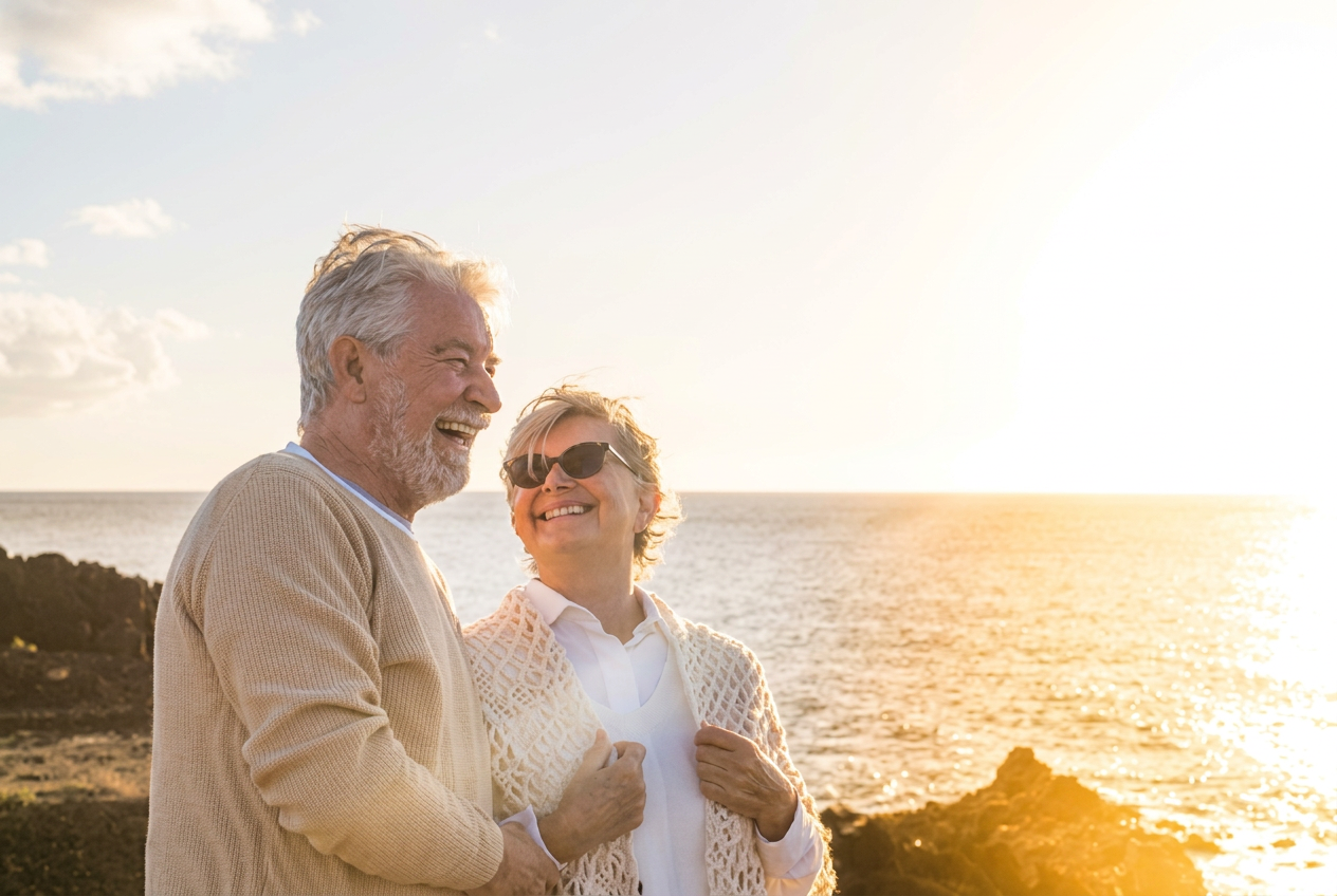 Older couple laughing together outdoors